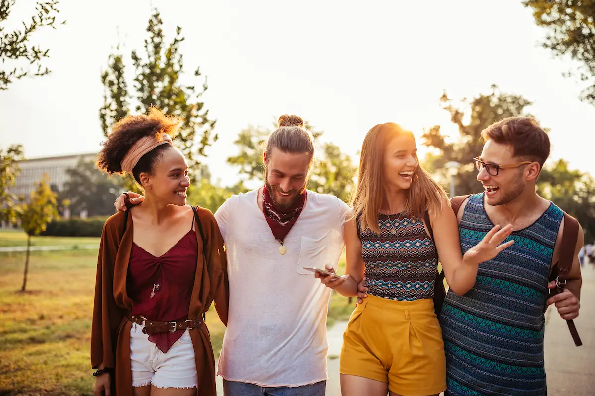 Group of friends laughing together on a sunny summer day